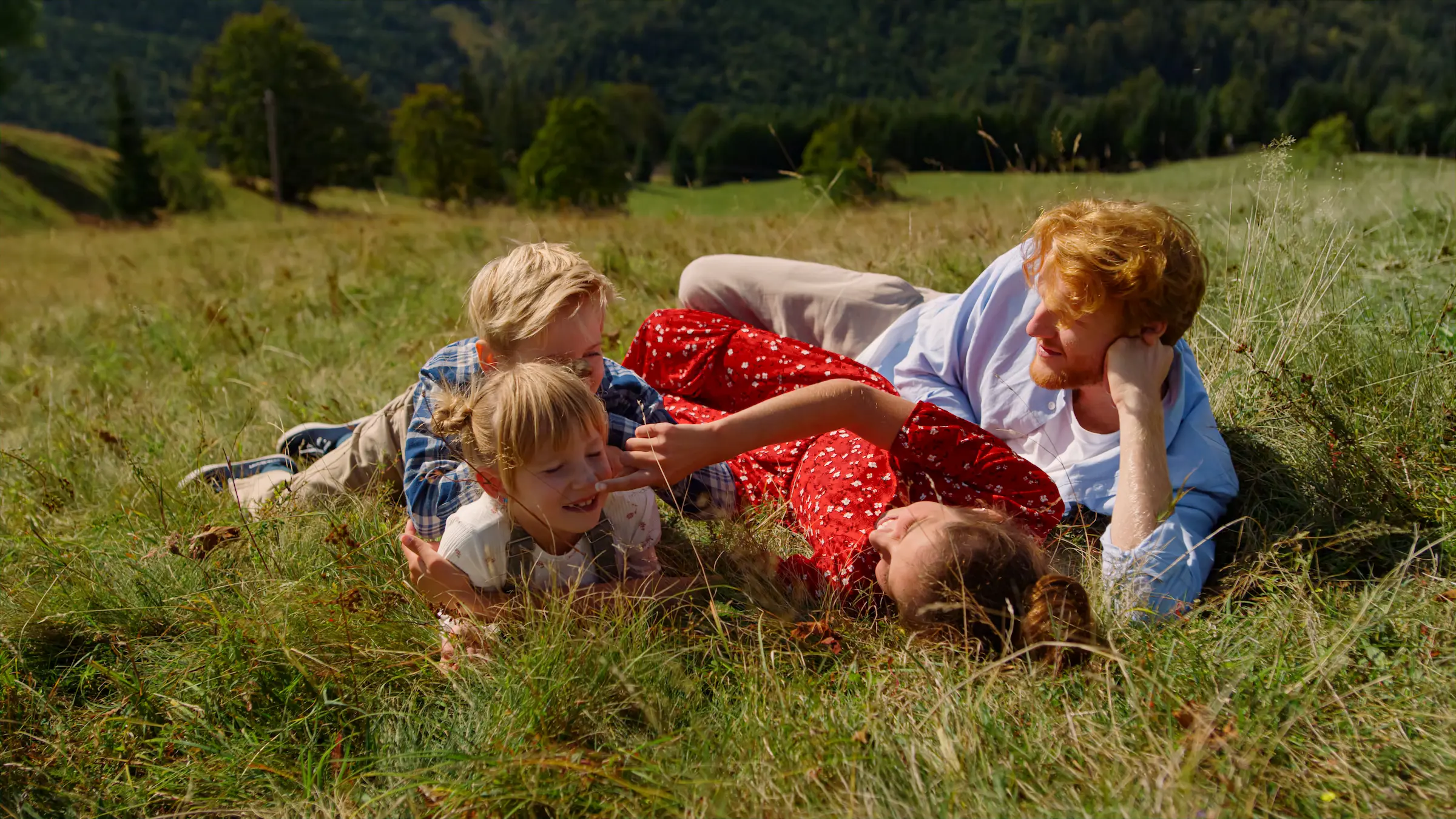 family-lying-green-grass-beautiful-slope-young-pa-2024-11-05-05-56-30-utc